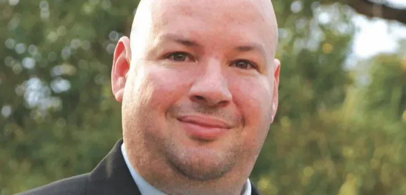 NHCC president Rolando Garcia standing outside smiling at the camera